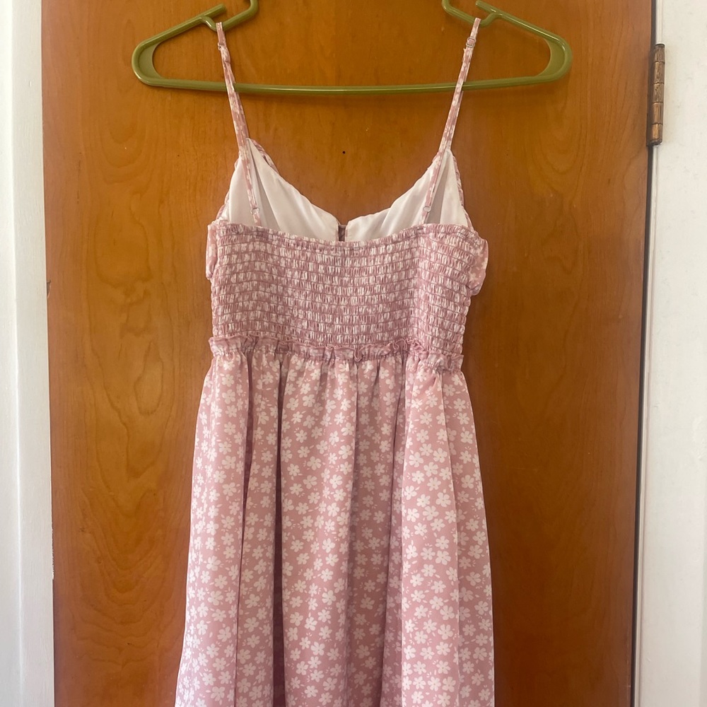 Pink and white flowered short, flowy dress with spaghetti straps.